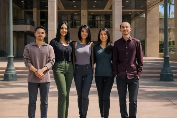 Four members of AFSCME Local 2002 stand outside Anaheim City Hall