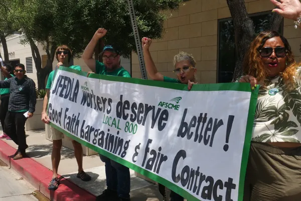 Photo of AFSCME Local 800 picket attendees holding a banner that reads in part JFEDLA Workers deserve better