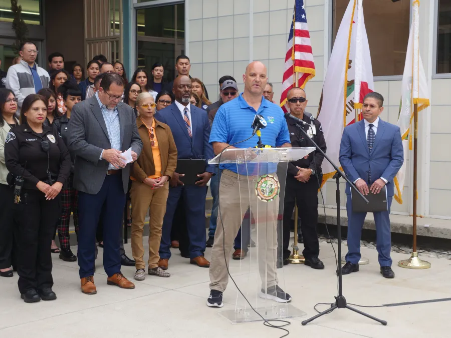 AFSCME Local 773 member stands at a podium during a press conference in Commerce, California