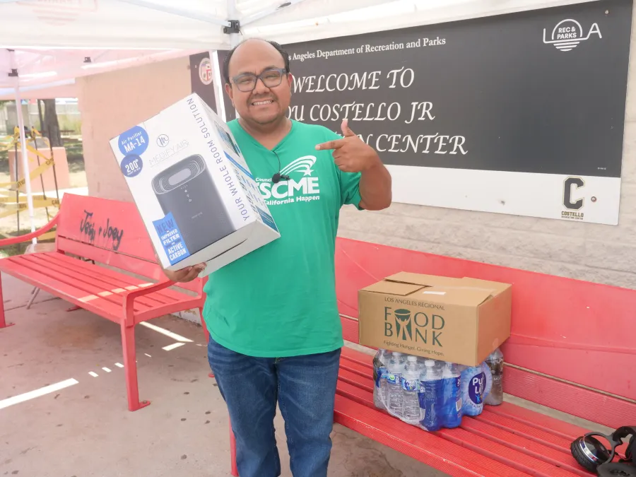 Photo of AFSCME Local 741 President holding an air purifier