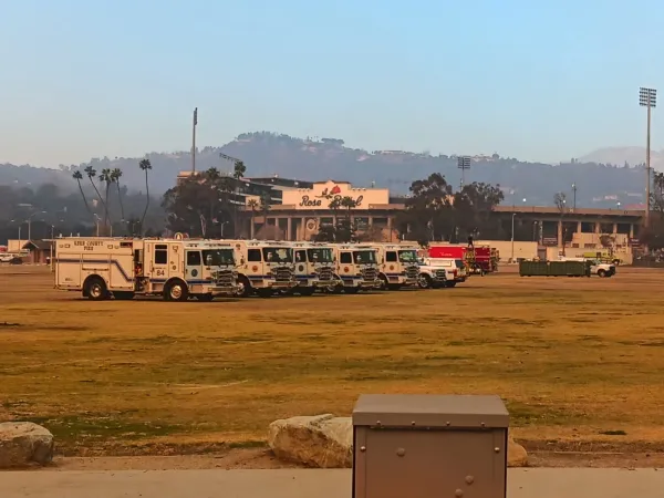 Row of emergency vehicles parked in an open field